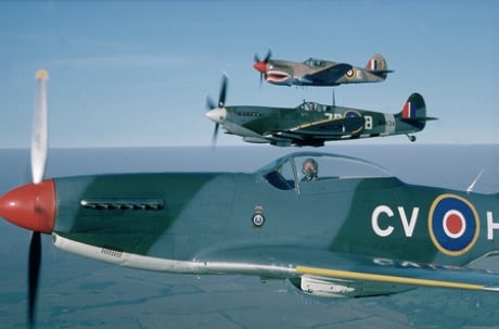 Three spitfire aircraft flying in formation