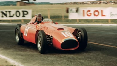 Old style red racing car on racing track