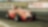 Old style red racing car on racing track