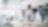 Three people wearing white lab coats talking