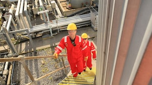 Shell engineers walking up stairway at a plant